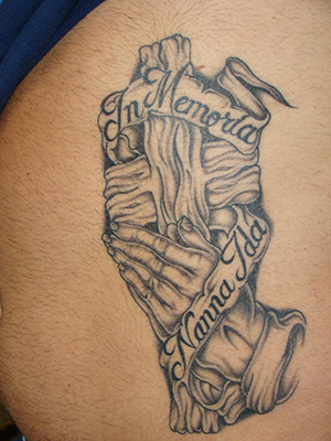 This is a large rib cage belly tattoo featuring a set of praying hands set 