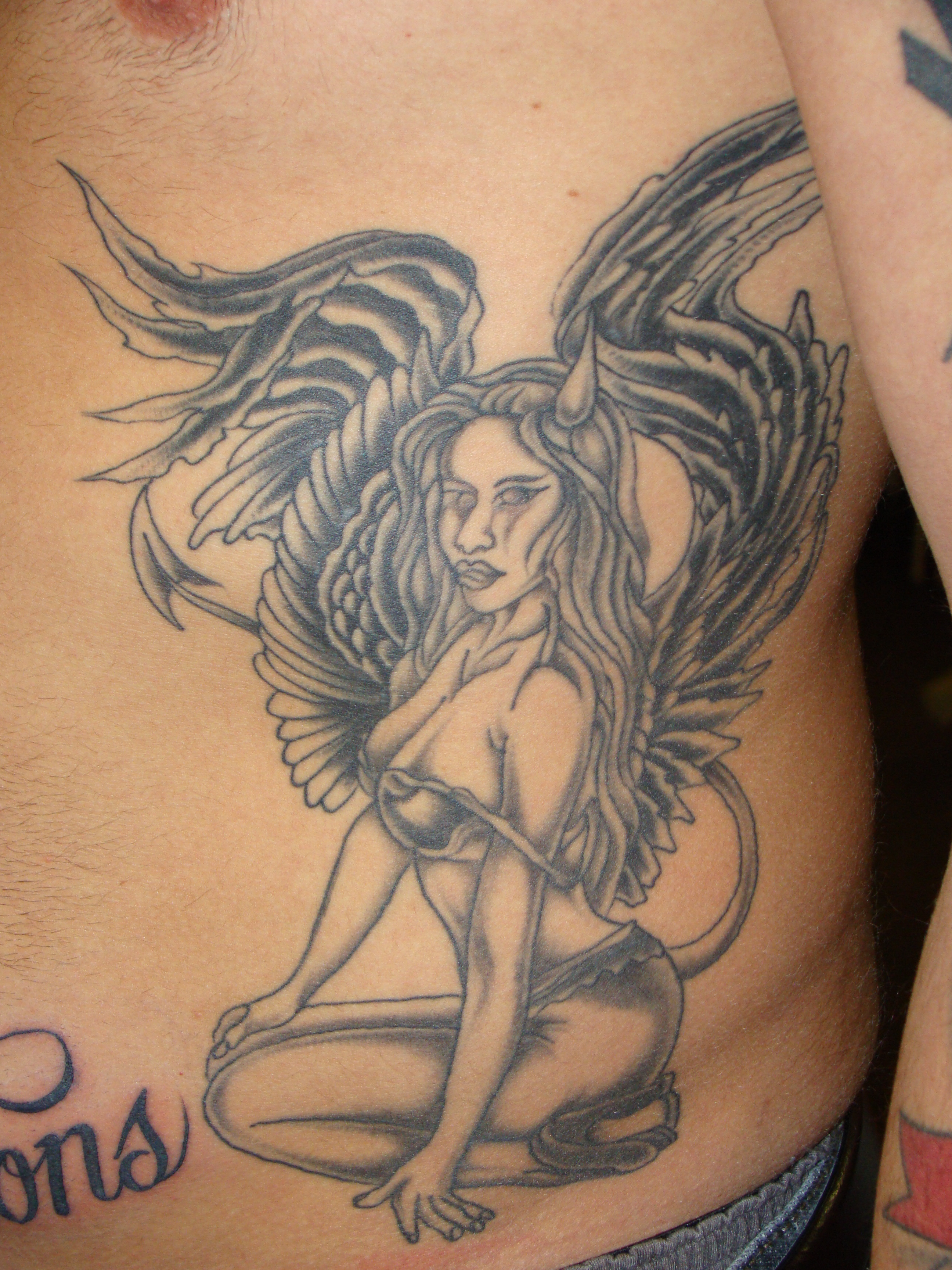 PinupGirlOnRibsTattoo