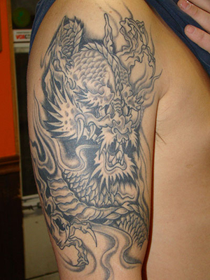 Black and White Dragon Arm Tattoo