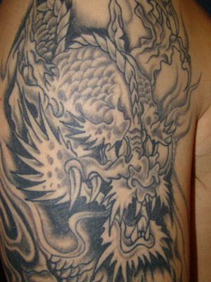 Black and White Dragon Arm Tattoo