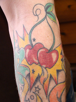Full Color Forearm Tattoo with Cherries Clovers and Stars