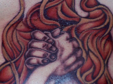 Full Color Hands Clasped Over Fire Tattoo