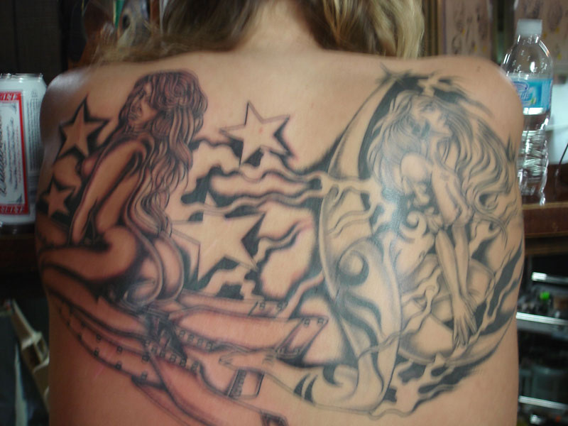 This is a full back tattoo featuring a pair of ladies.