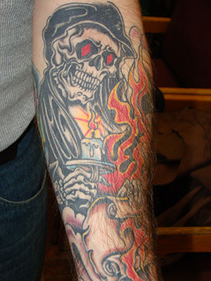 Flaming Skulls Arm Tattoo