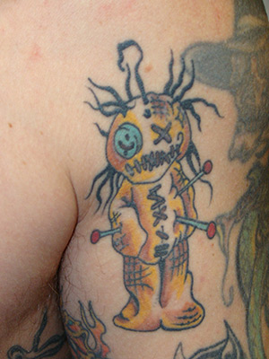 This is a badass voodoo doll tattoo placed on the upper left bicep of the 